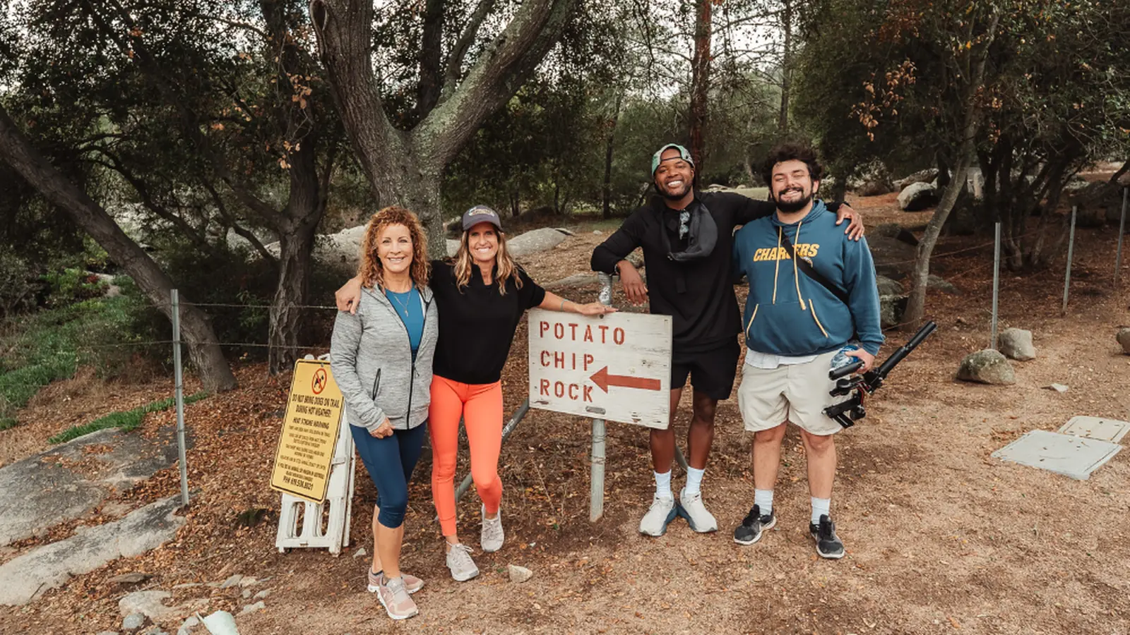 Karen Pietsch, Ty Hines, and team at the Potato Chip Rock trail sign at the Mount Woodson Trailhead in Poway