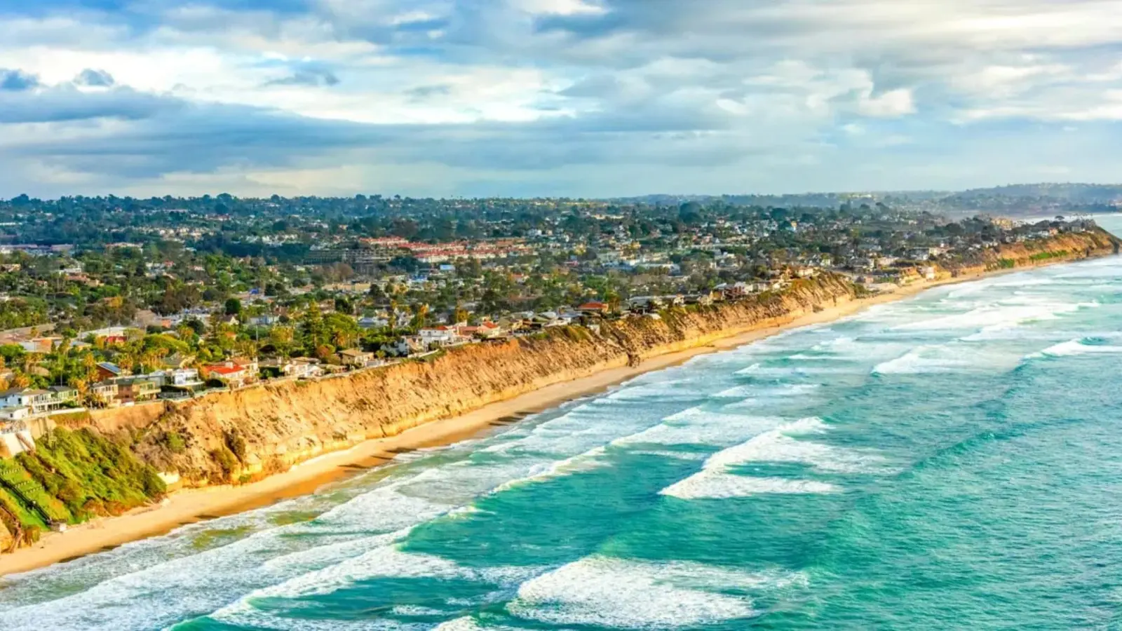 Scenic coastline in North County San Diego with blue ocean, sandy beaches, and sunny skies