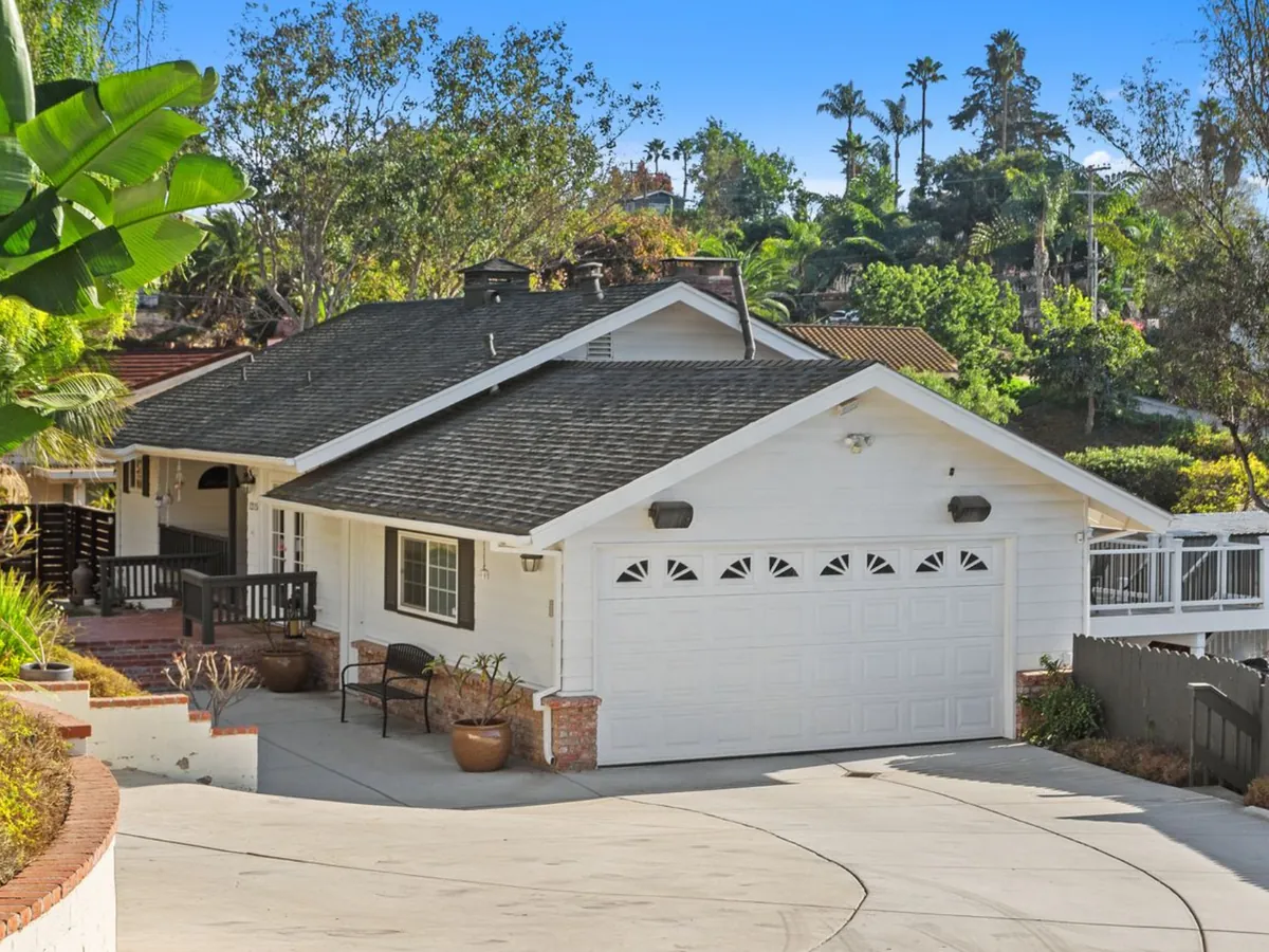 White single-story home with palm trees in North County San Diego