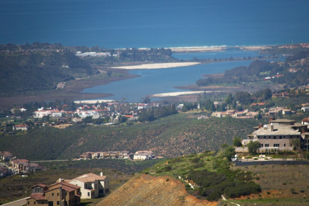 View across Batiquitos Lagoon toward the ocean with hillside homes in South Carlsbad