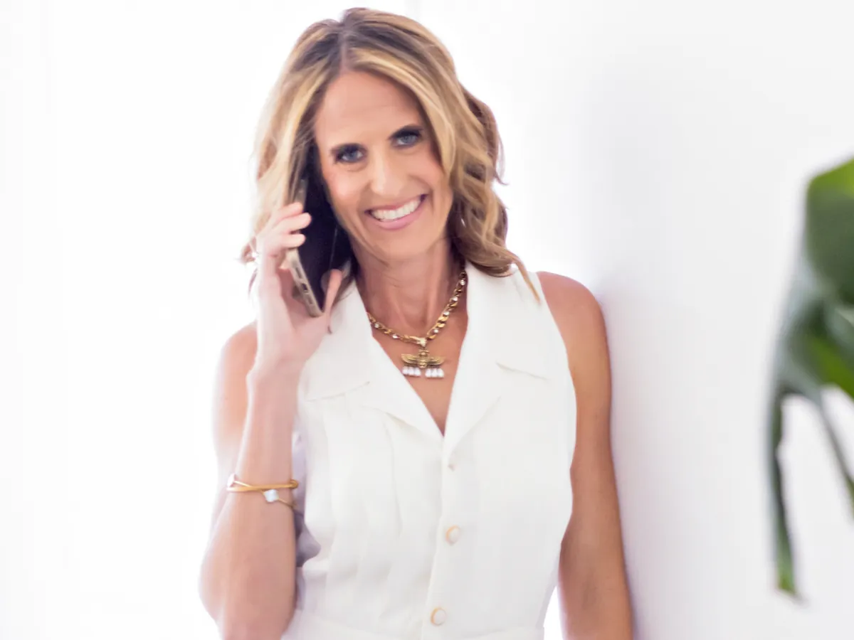 Karen Pietsch smiling on the phone while negotiating offers for a seller